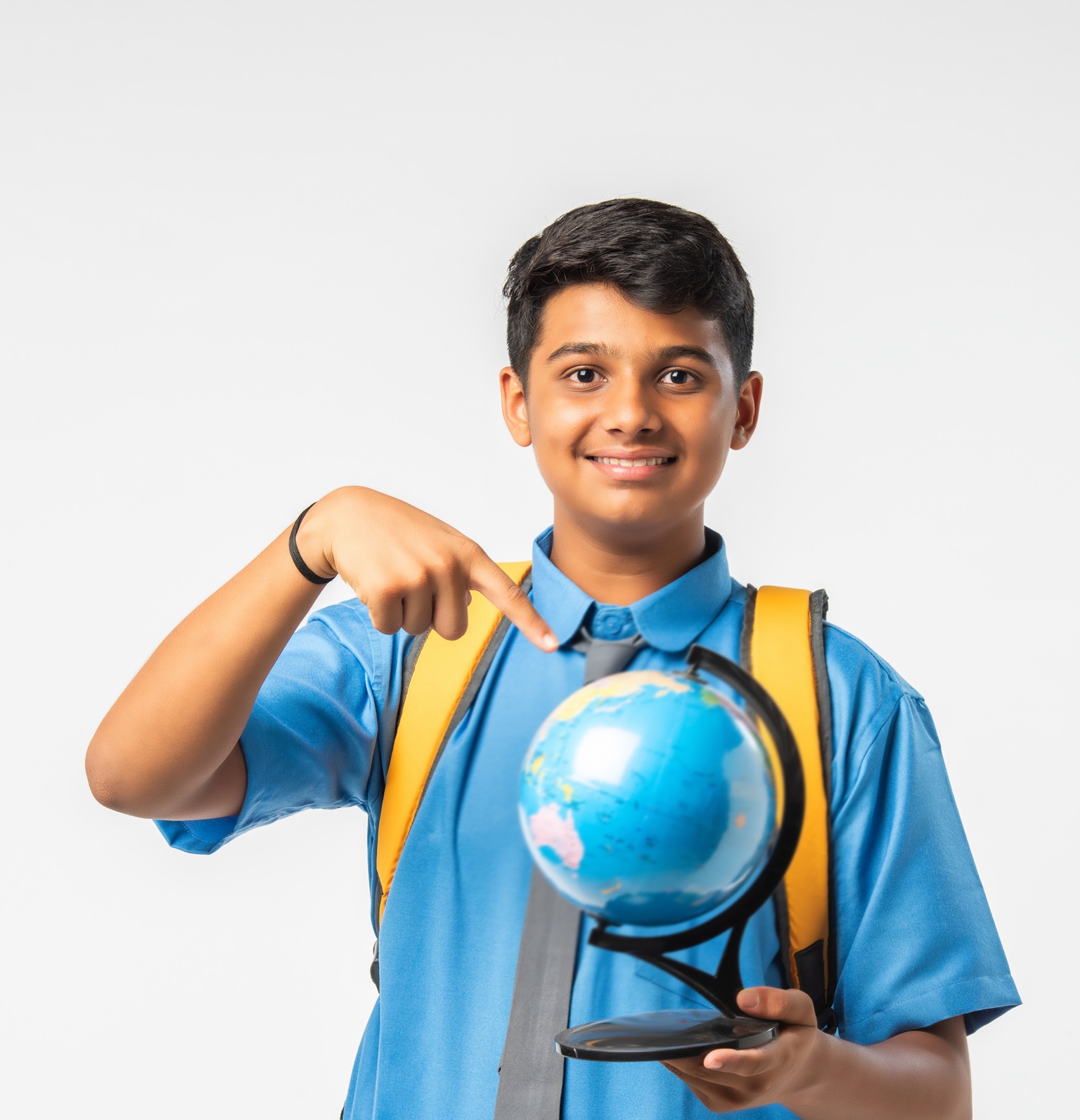 Indian Asian Teenage Schoolboy Enthusiastically Studying Geography While Holding a Globe Model, Isolated Against White Background, Embracing Global Learning and Education